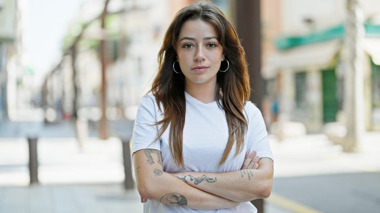 contemplative young woman with tattoos